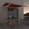 Auvent manuel rétractable avec LED 450x300 cm Orange et marron
